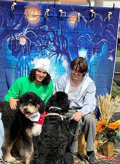 Volunteers with black doodles at Halloween event.
