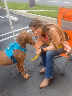 Woman bonding with a golden doodle.