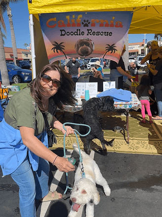Woman with a white doodle at an event.